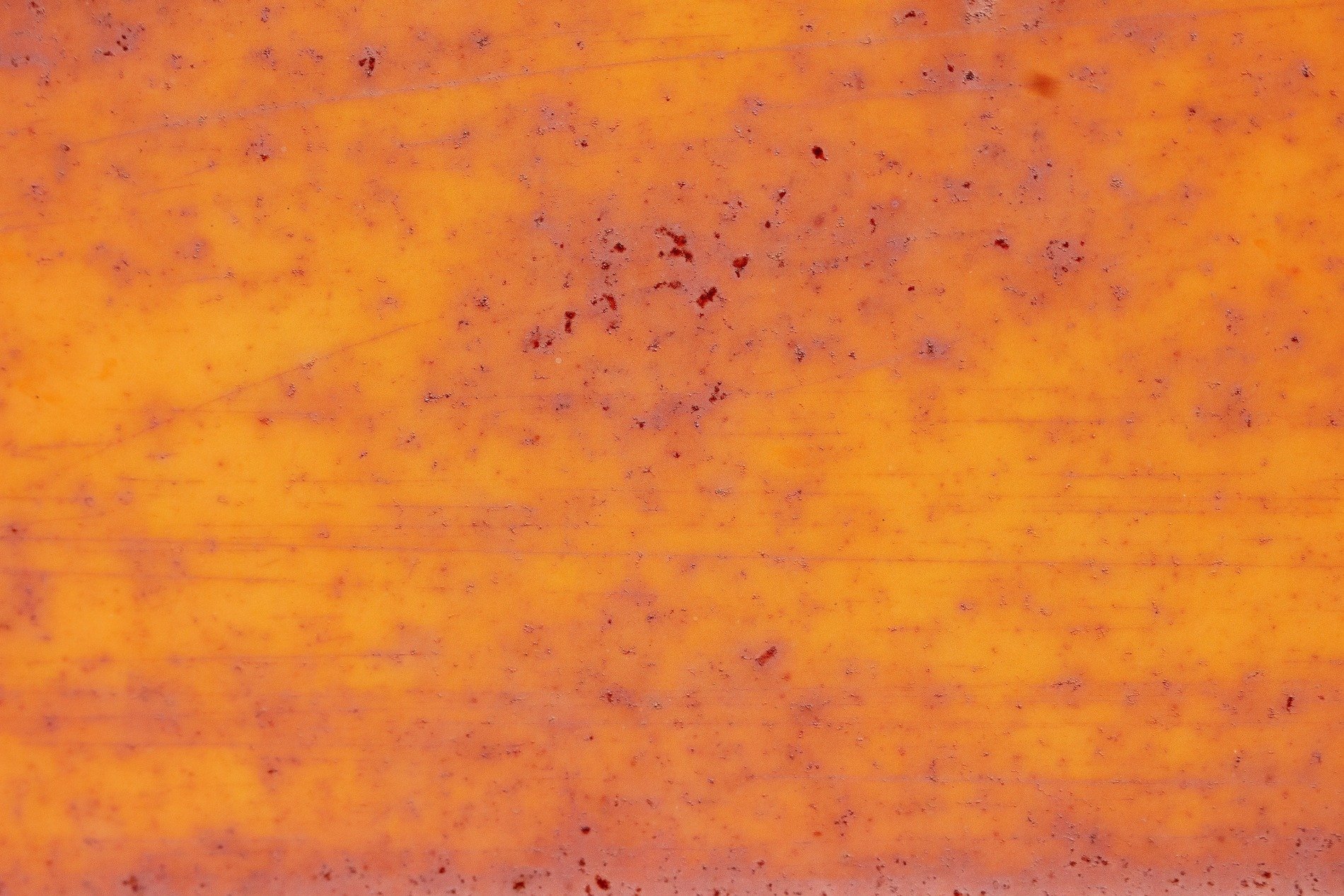 Orange paint grows thin, iron turns to reddish dust, metal bleeds with age