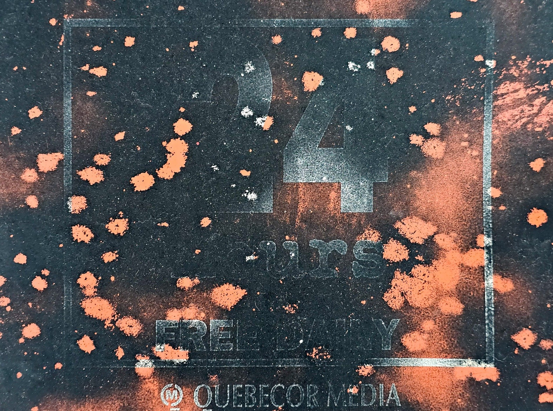 Orange paint splatters, stenciled hours on the box, grit claims every line