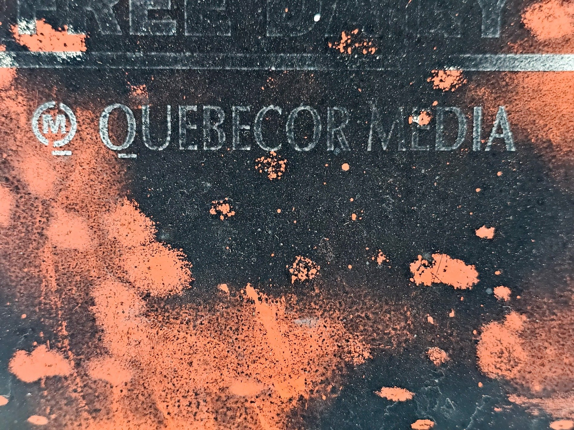 Orange splatters fall, Quebecor name starts to fade, time wears down the brand