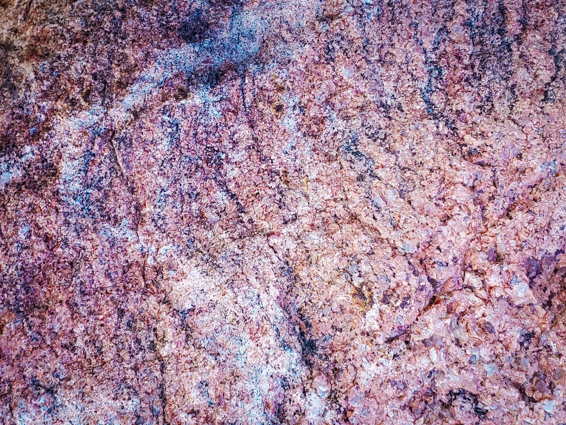 Pink fields meet the grey, mottled grain holds the surface, stone marks the finish