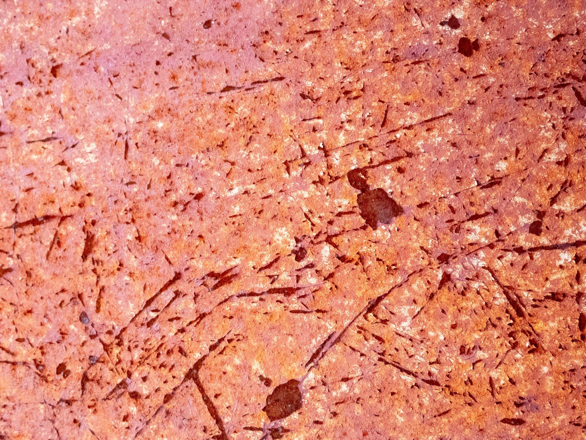 Red clay holds the heat, deep scars cross the pitted stone, ancient dust remains