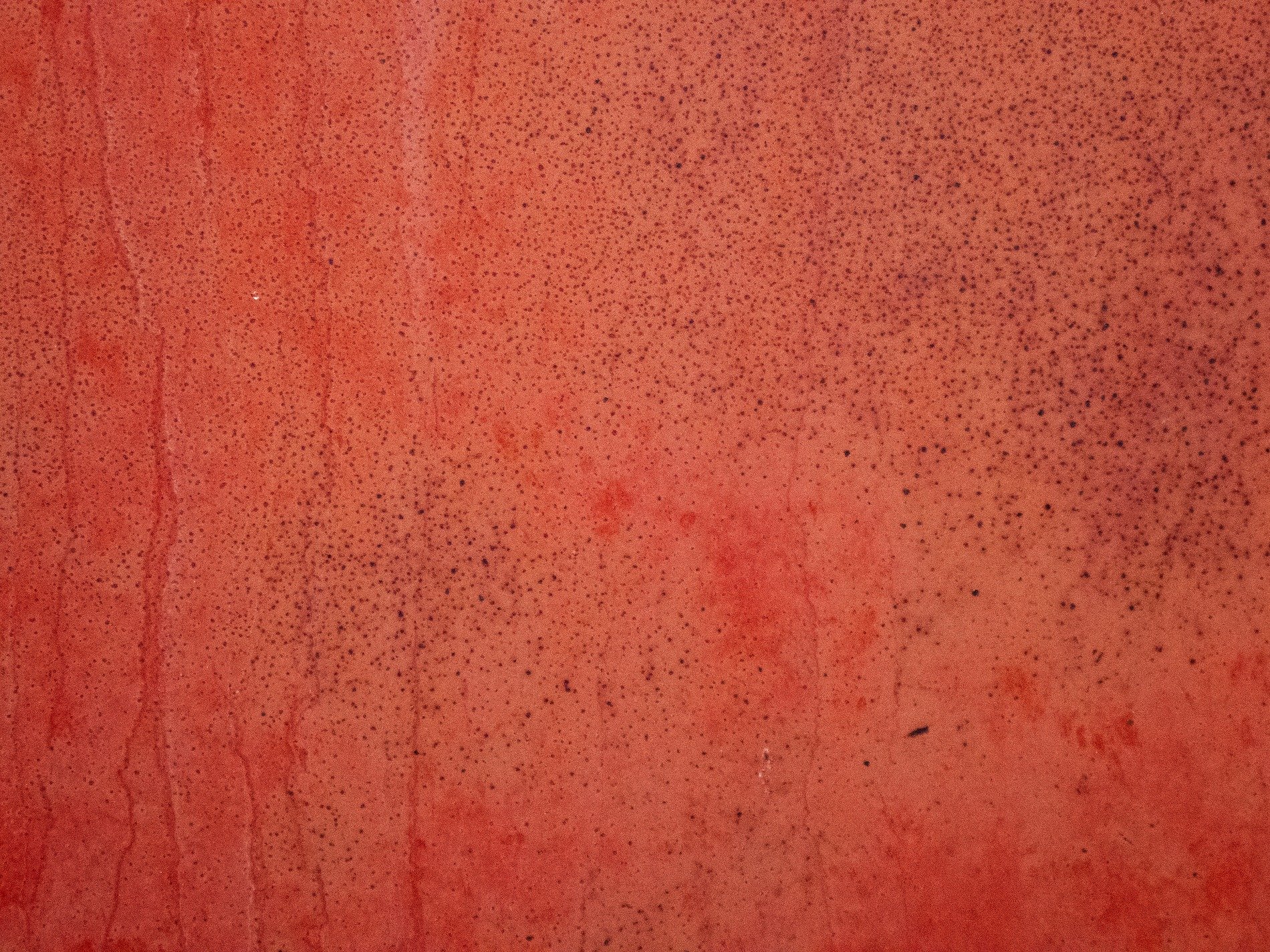 Red fields meet the light, faded skin holds the surface, grit marks the finish