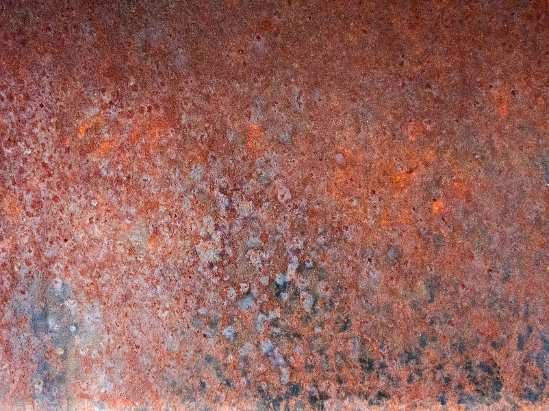 Orange oxidation, decay eats the iron plate, time blooms into dust