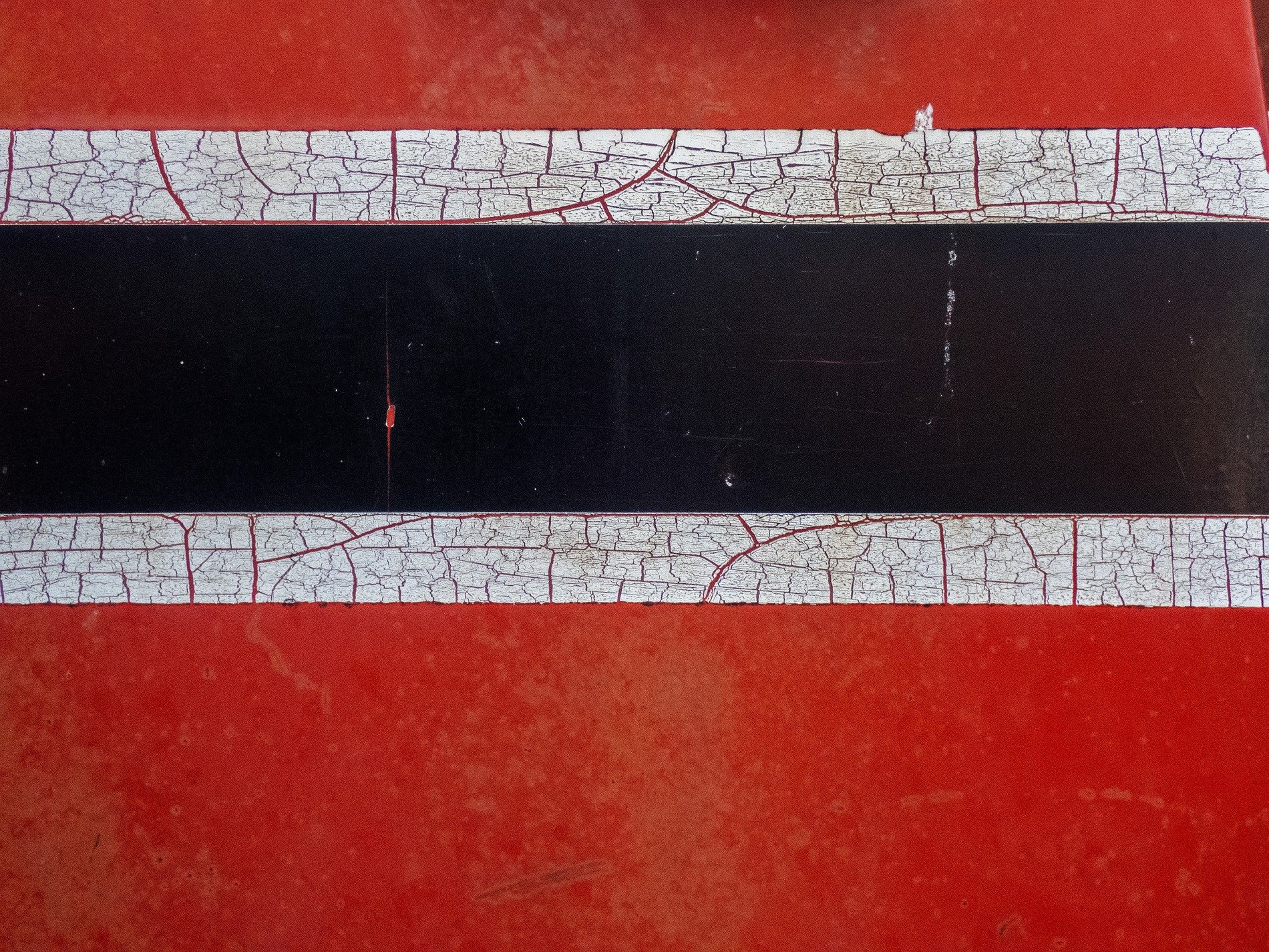 Red fields meet the sun, faded skin holds the surface, grit marks the finish