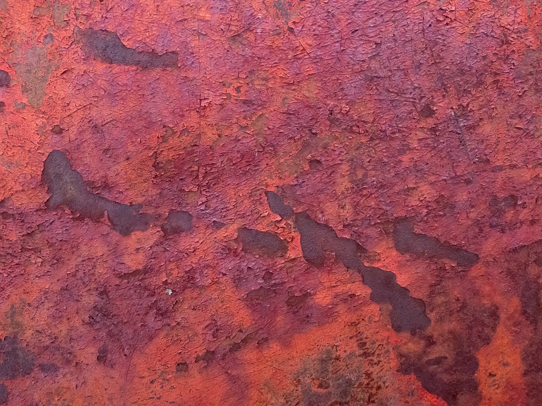 Red flakes curl and peel, iron yields to constant air, deep rust marks the years