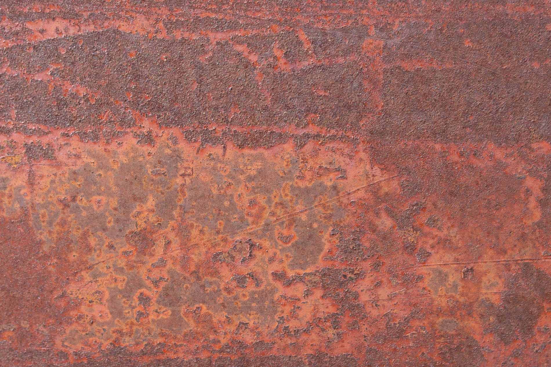 Red iron decays, oxidation eats the metal, texture born of time