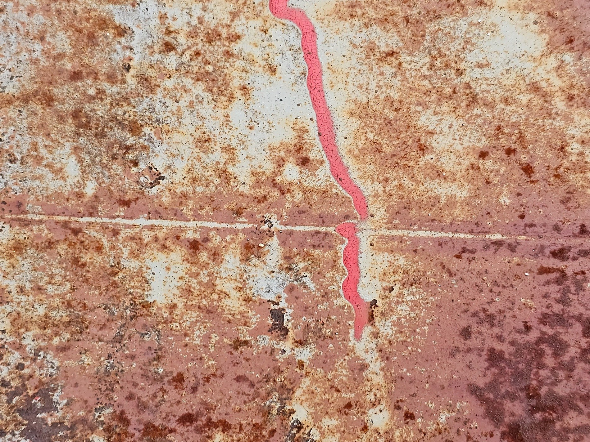 Red line carves the white, rust trails trace the heavy metal, light marks the surface