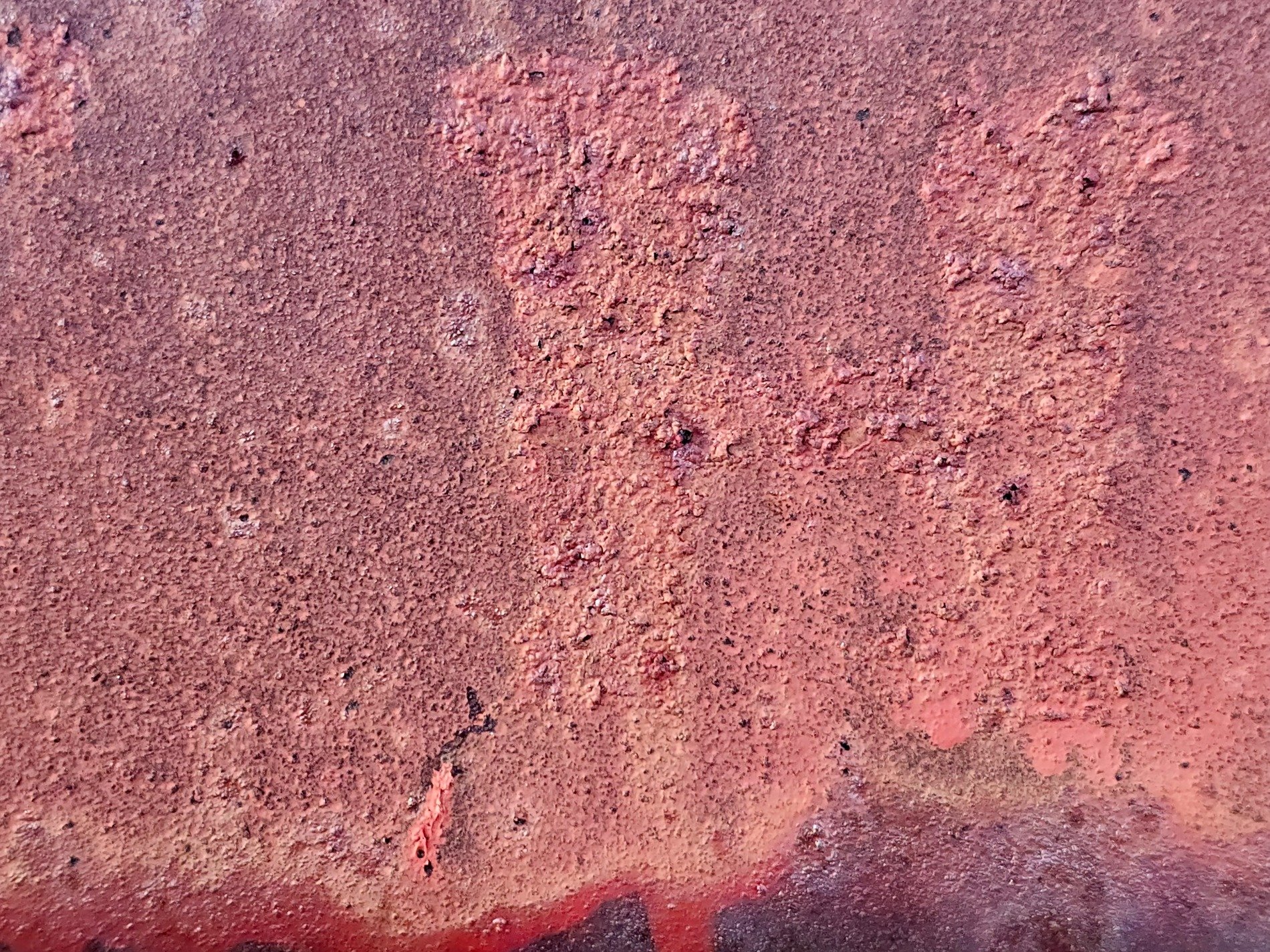 Red rust flakes away, orange grit on ancient steel, metal turns to dust