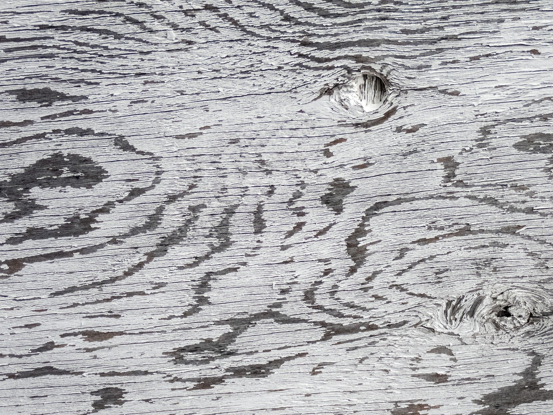 Red skin fades to grey, vertical lines trace the field, grit holds the center