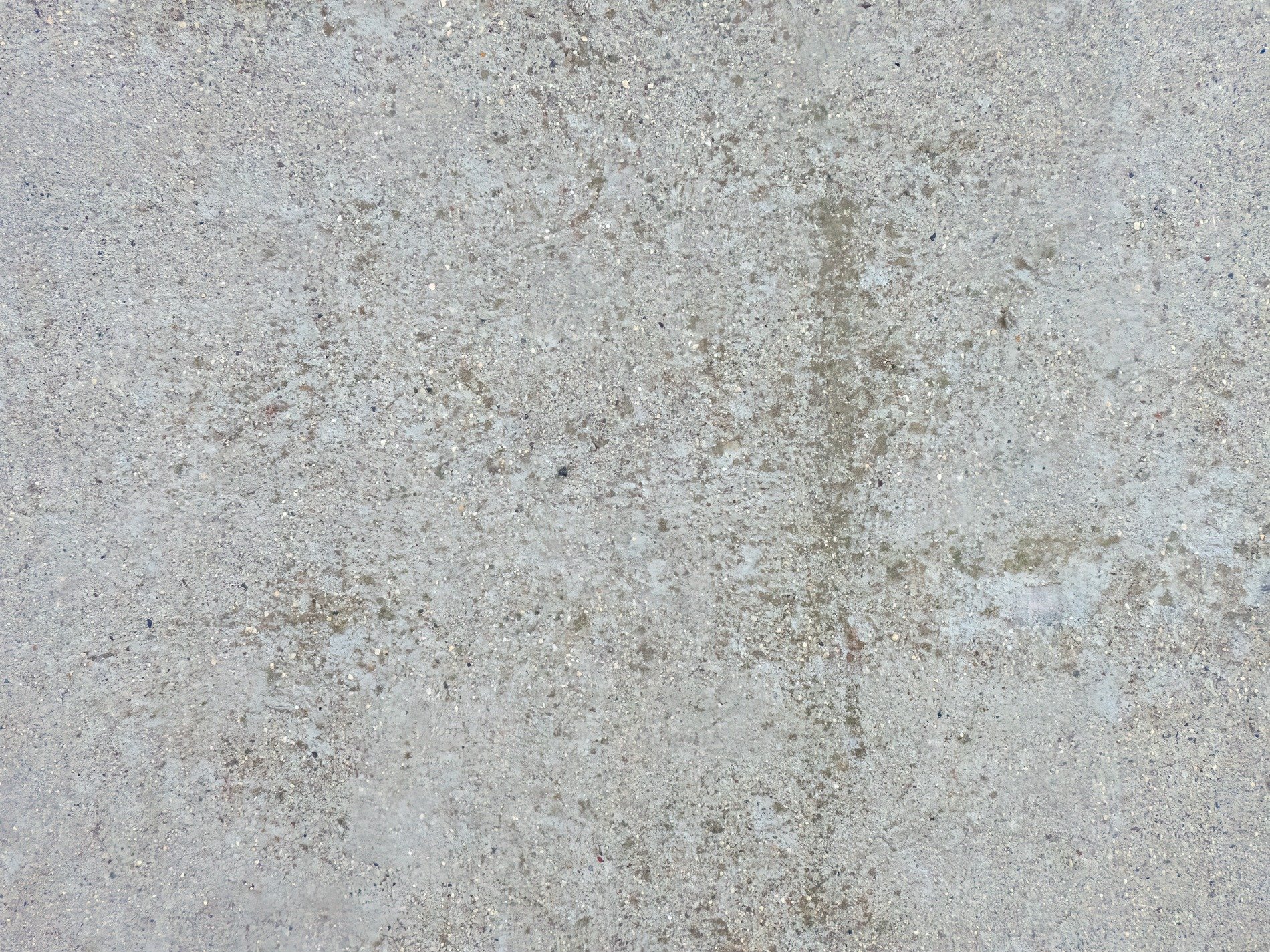 Rough concrete surface, tiny stones embedded deep, weathered path of grey