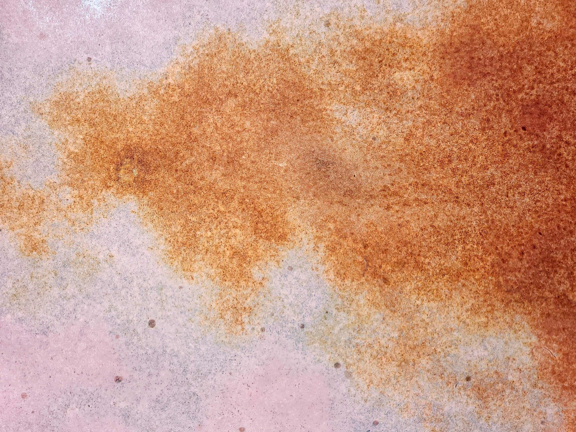 Rust blooms on the plate, iron yields to ancient air, orange dust remains