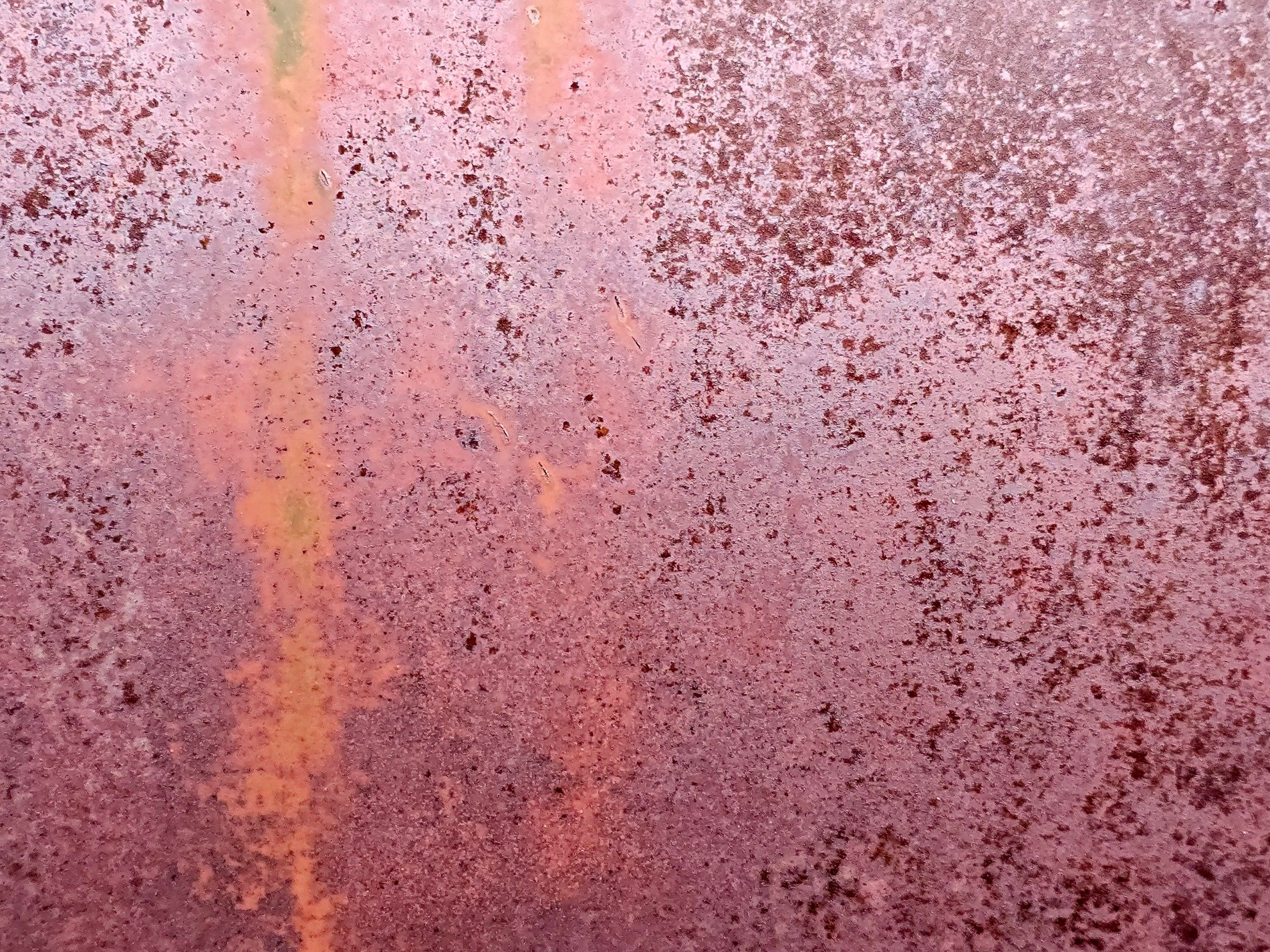 Rust blooms on the steel, pitted surface tells the tale, iron turns to dust