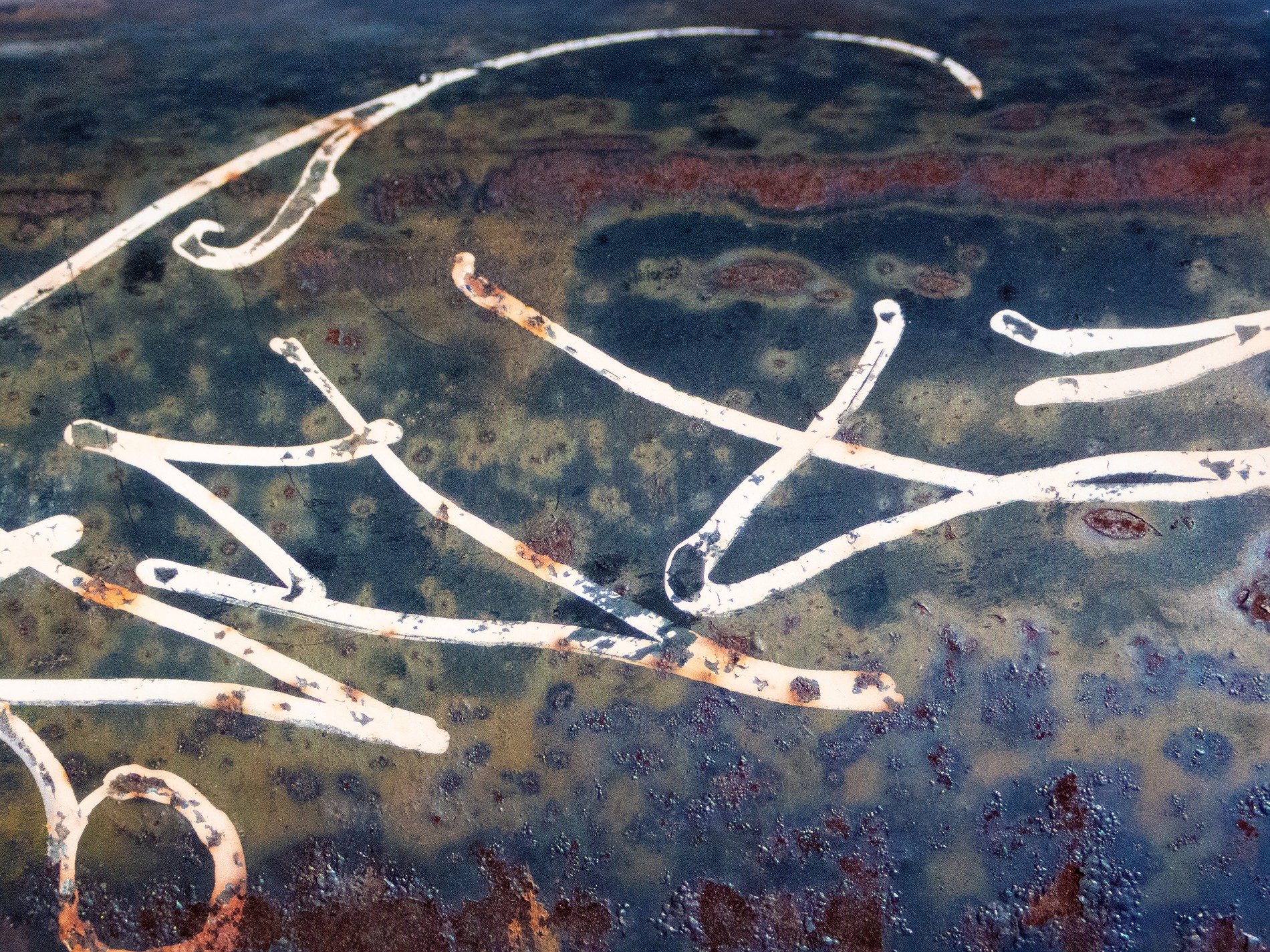 Rust eats through the steel, white ink dances on decay, shadows meet the light