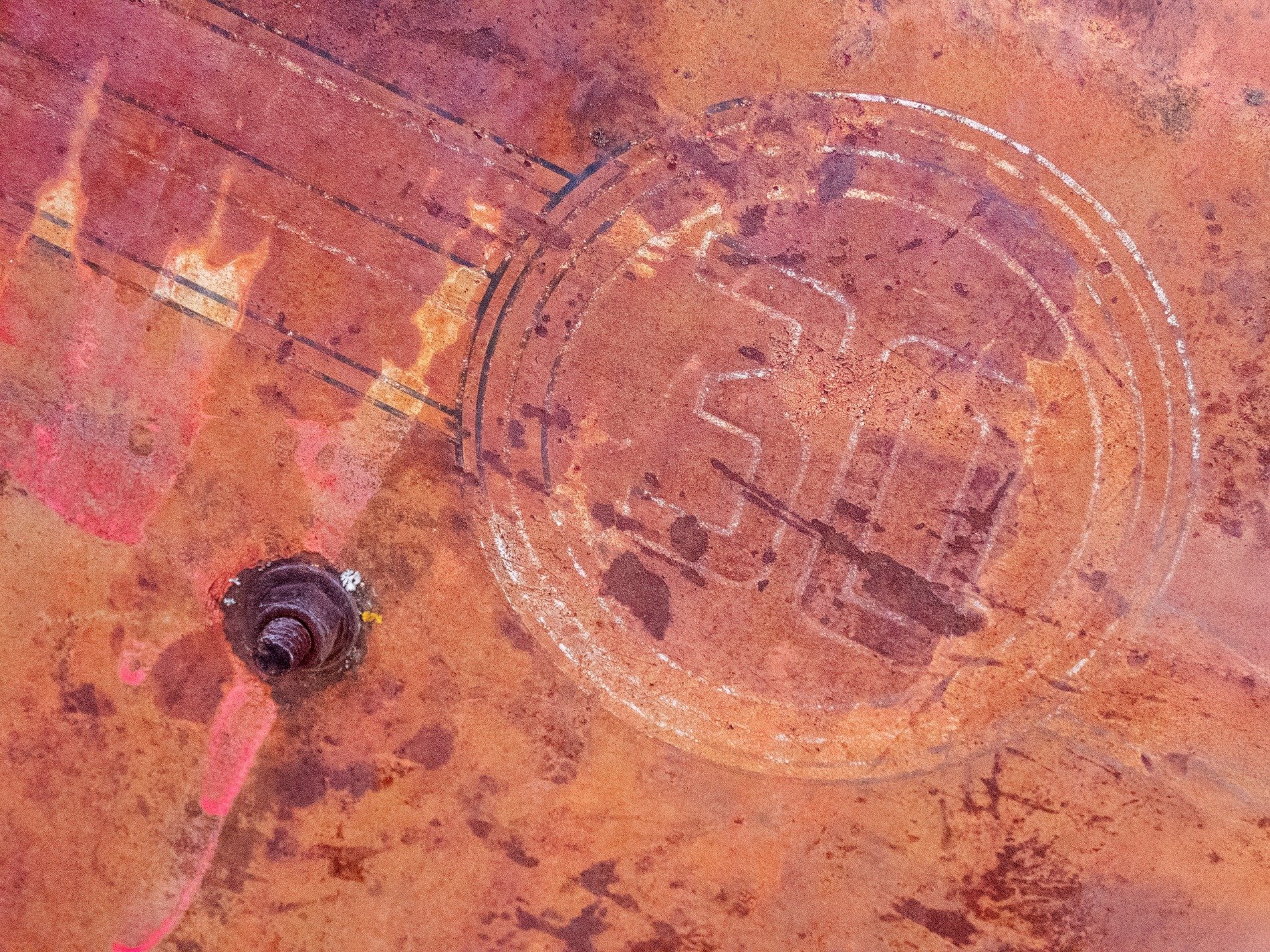 Rusty thirty stays, orange grit claims the metal, time marks the heavy