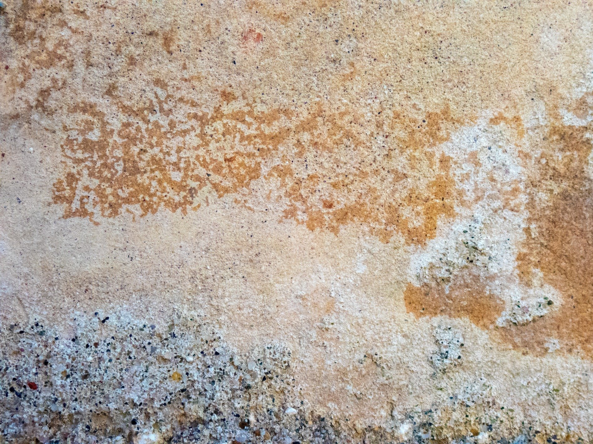 Sandy textures mix, rusty stains across the slab, gritty base remains
