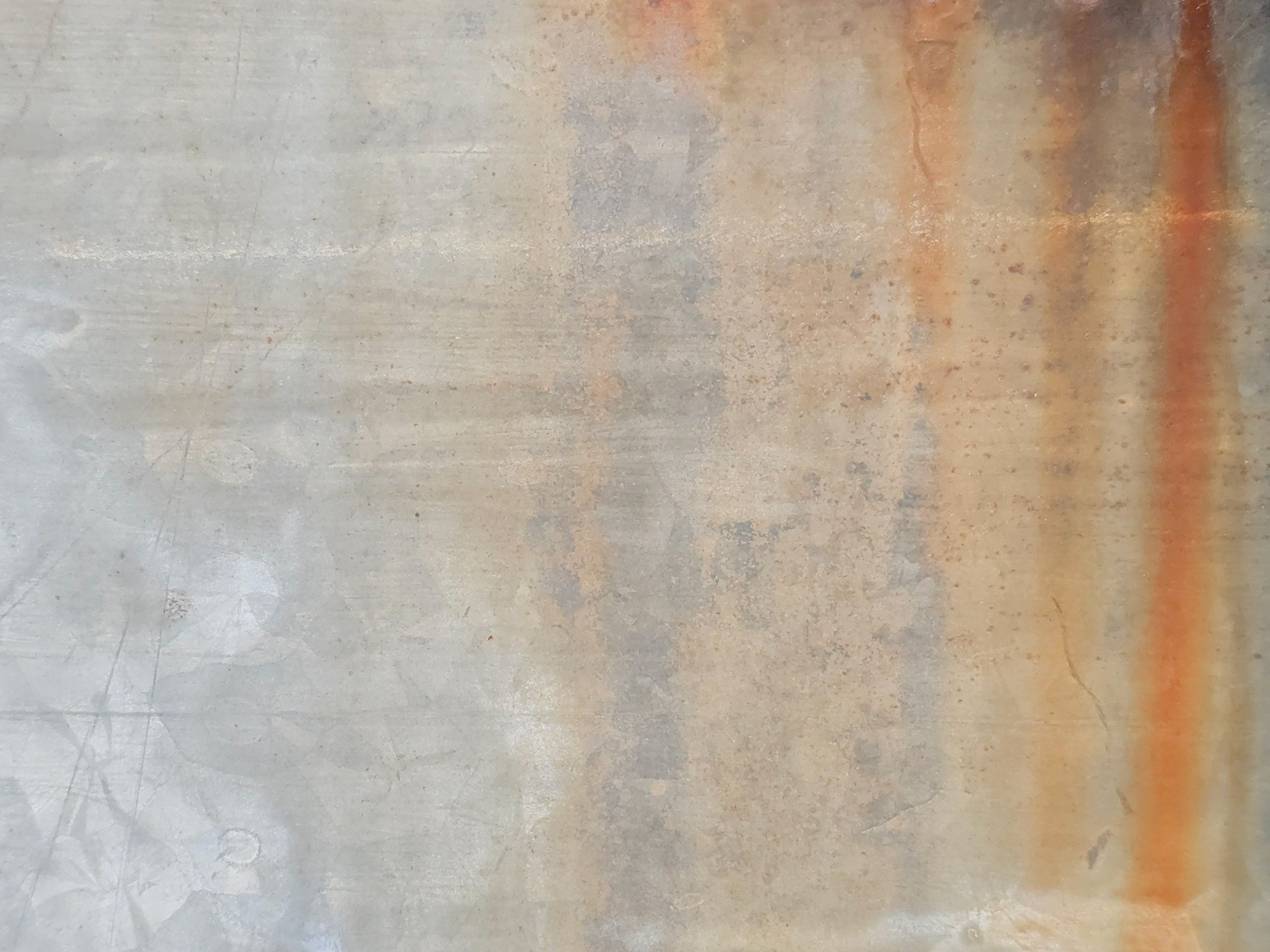 Scratches on the sheet, rust trails bleed down grey metal, time leaves orange marks