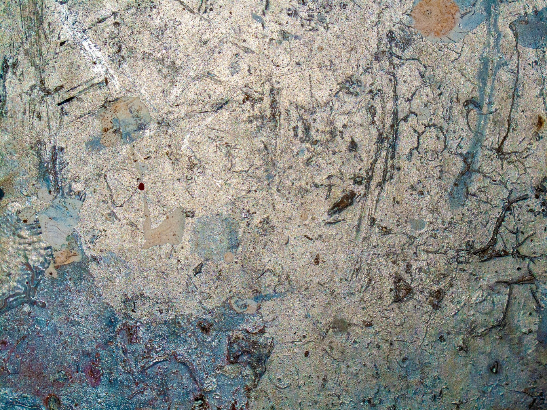 Silver metal scars, traces of blue paint remain, time wears down the shine