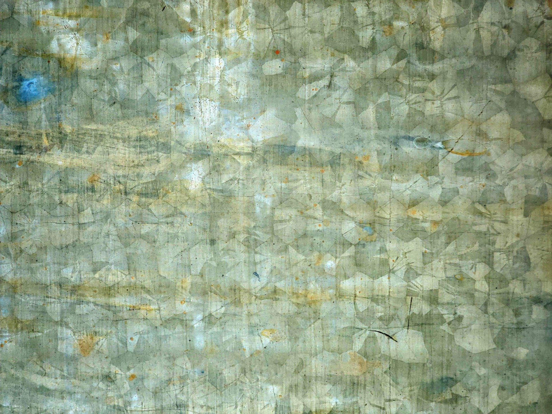 Silver scales align, weathered metal shows its age, rust blooms on the sheet