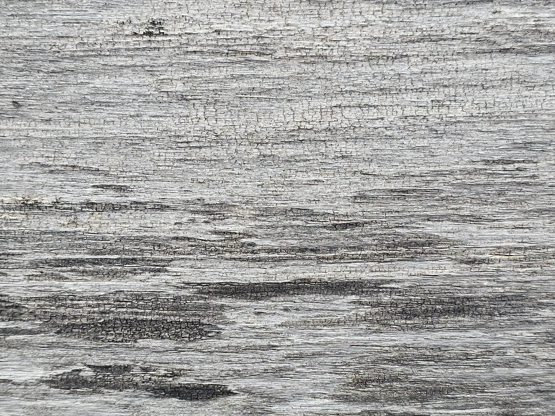 Silver wood grain fades, time etches horizontal paths, aged texture remains