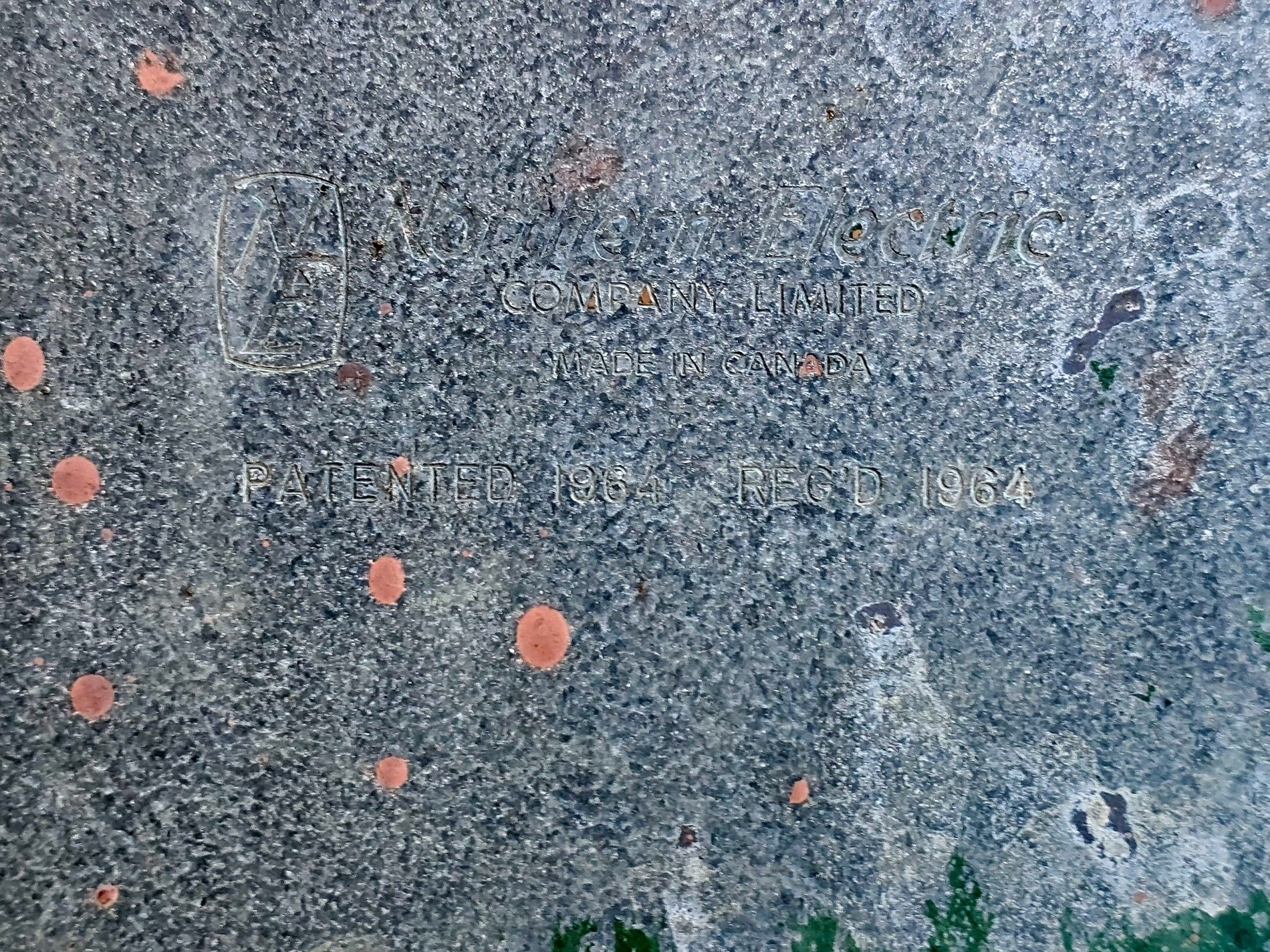 Stamped in cold grey steel, Canadian heritage fades, red dots mark the time