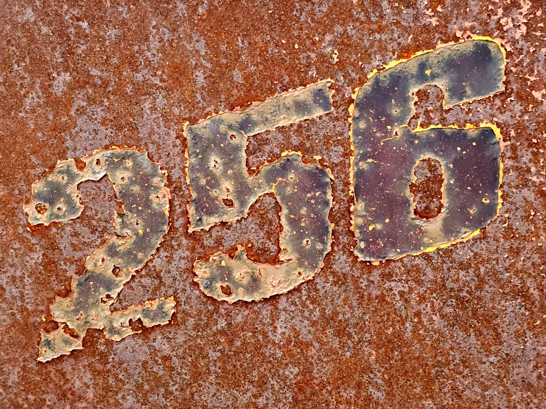 Stenciled numbers meet the rust, heavy grit claims the surface, time leaves a deep mark