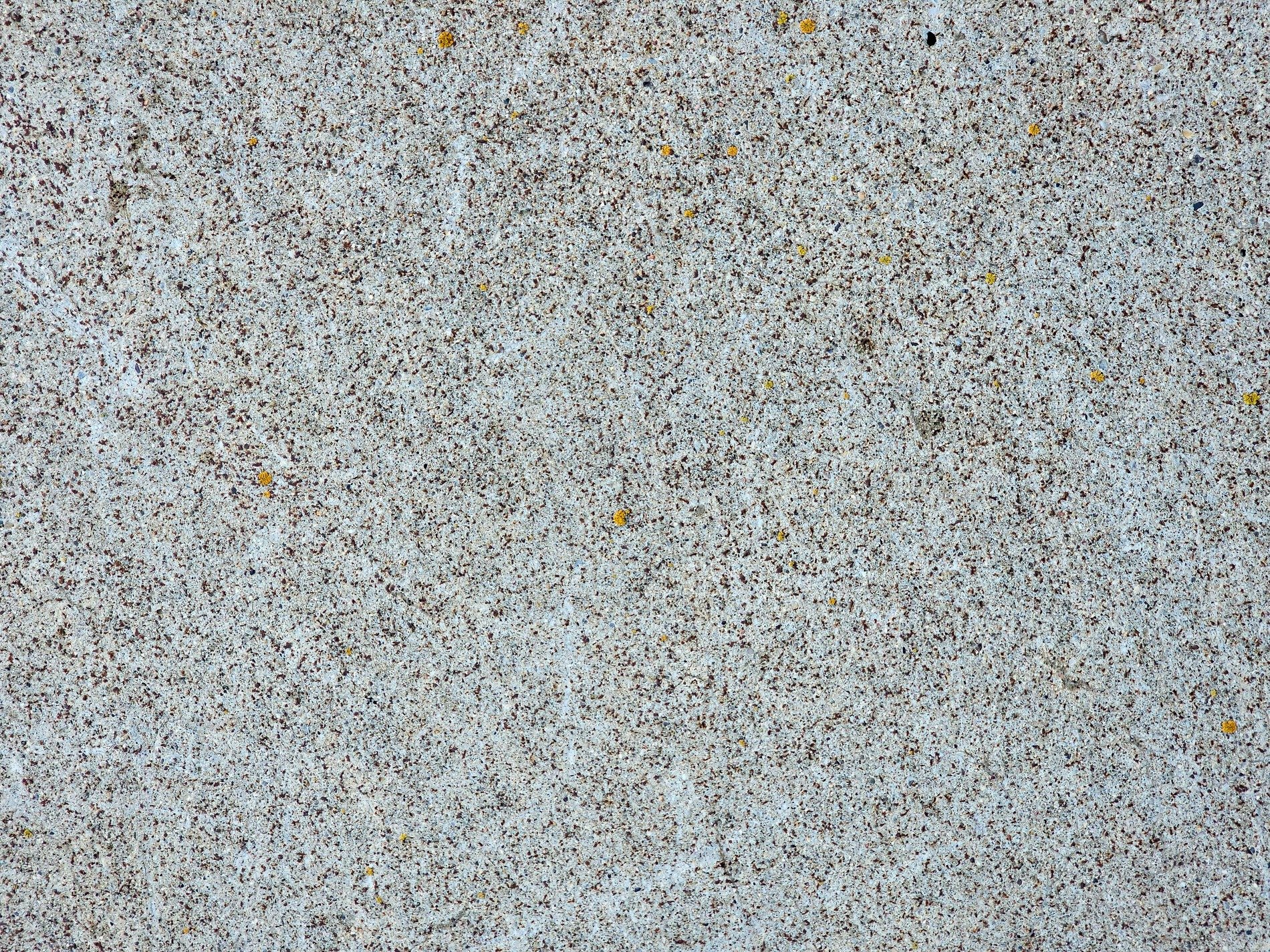 Tan skin has deep paths, jagged scars trace the heavy stone, light carves the surface