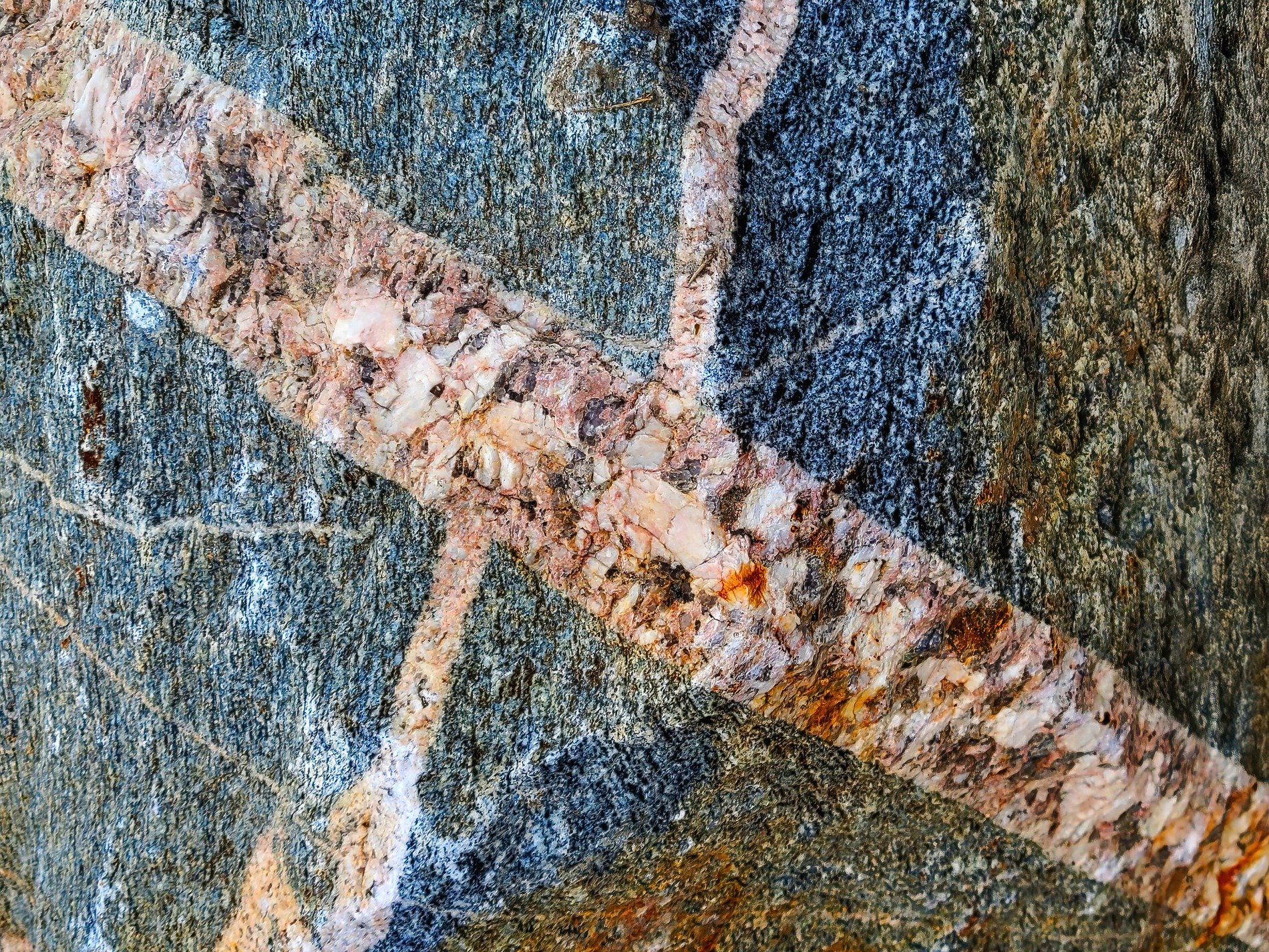 Tan skin holds the light, ancient paths trace the surface, stone marks the heavy