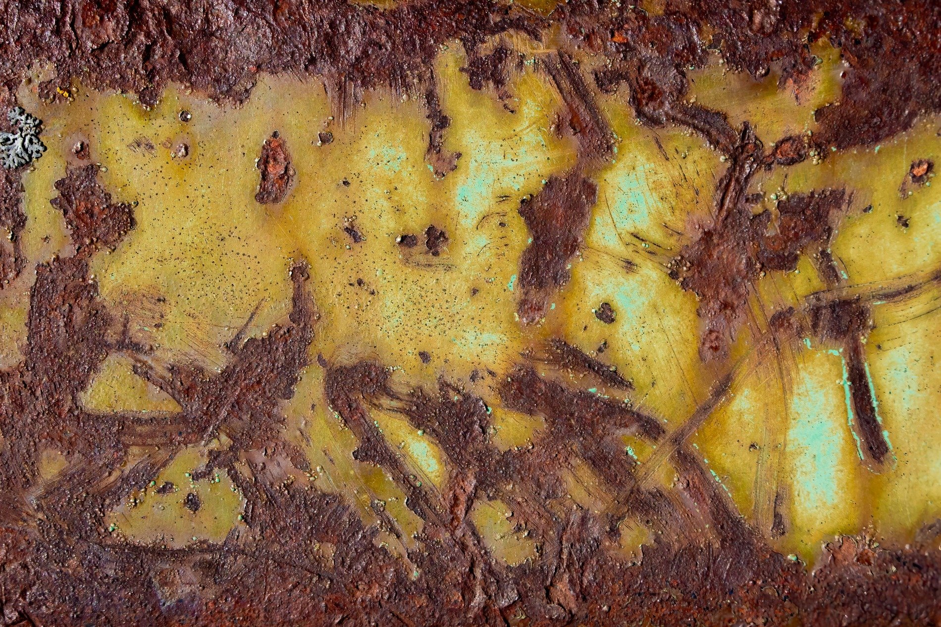 Red rust eats the edge, yellow paint fades into teal, time scars the hard steel