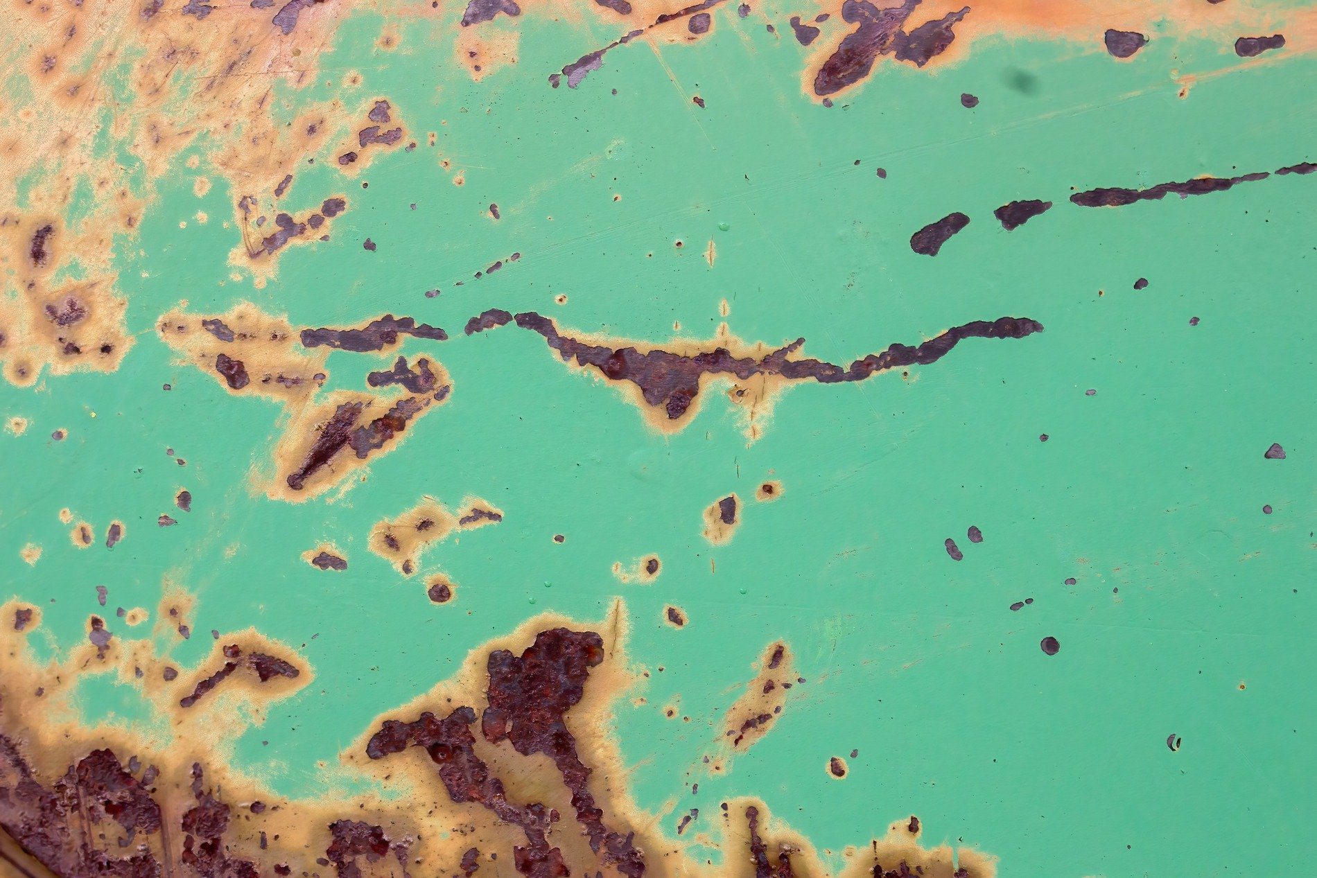 Green paint fades away, orange rust eats through the steel, time's slow rough decay