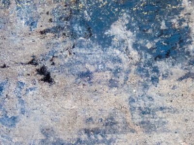 Azure fades to grey, gritty stone meets weathered paint, time erodes the ground