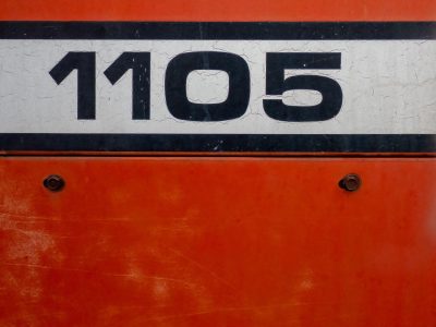 Black numbers hold tight, orange fields meet the heavy, light marks the finish