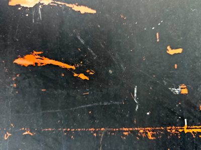 Black steel wears its scars, orange flares break through the dark, time reveals the core