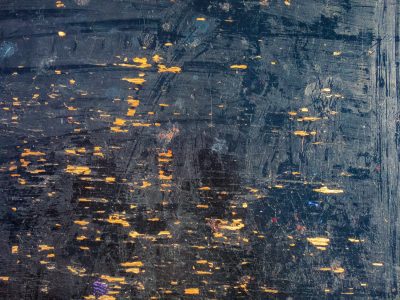 Blackened skin wears thin, orange wood peeks through the scars, many years of work