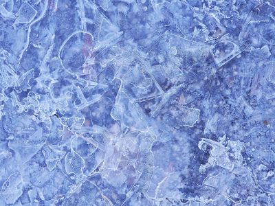 Blue frost weaves a web, frozen glass shards hold the light, winter's cold embrace