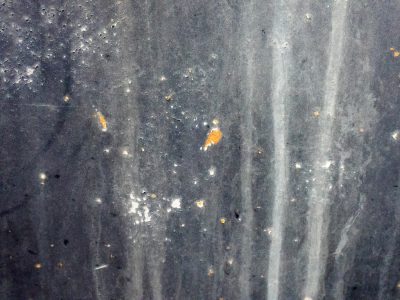 Blue paint flakes away, orange spots claim the heavy, grit marks the finish