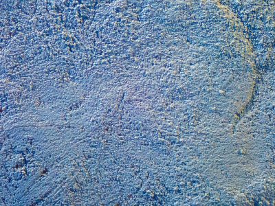 Blue peaks catch the light, rough stone wears a jagged line, shadows pool in deep