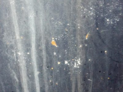 Grey paint starts to flake, streaks of rain wash down the dark, orange rust takes root