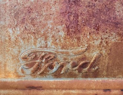 Blue skin has light marks, jagged scars trace the field, grit marks the finish