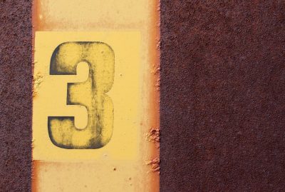 Yellow number three, rust consumes the metal sheet, time marks its decay