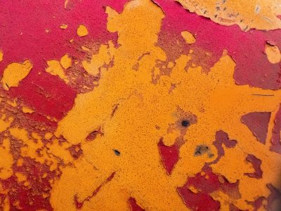 Bright orange flakes off, crimson depths are laid to bare, surfaces dissolve