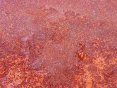 Red oxide blooms wide, iron skin starts to decay, time stains the surface