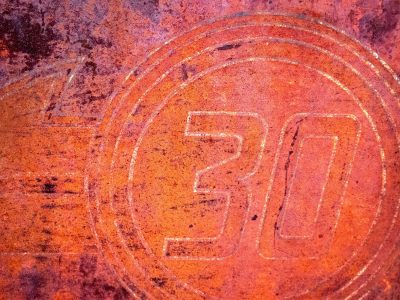 Circular marks meet the grit, heavy rust claims the numbered field, years leave a deep trace