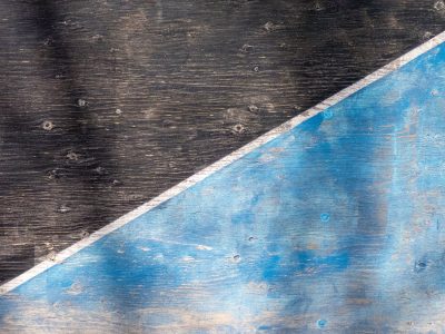 Dark fields meet the blue, diagonal lines divide, light marks the surface