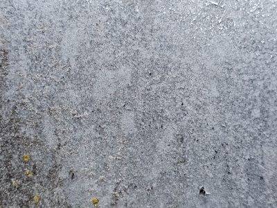 Dark grains flow through deep, jagged lines trace the surface, light marks the finish