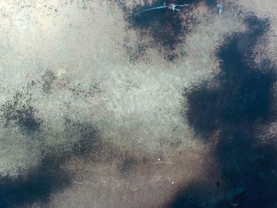 Dark stains on the steel, mottled surface shows its age, cold metal holds time