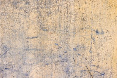 Pale gold paint fades out, indigo scratches remain, worn skin of the wall