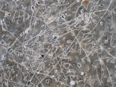 Deep lines mar the stone, etched letters fade with the years, history carved in rock