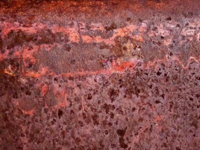 Deep pits hold the light, orange grit claims the heavy, time marks the stone