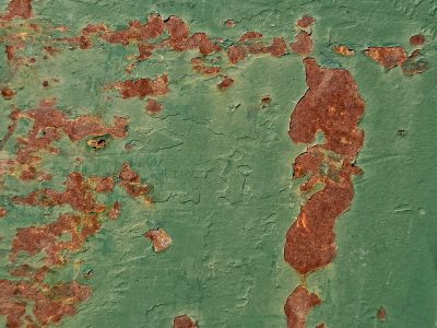 Green fields meet the rust, orange spots claim the heavy, time marks the metal