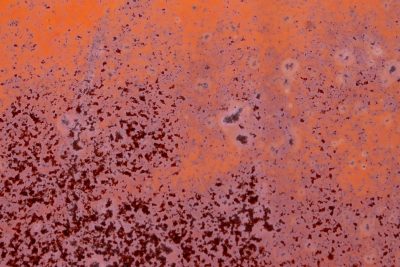 Orange surface peels, crimson rust eats through the steel, time etches its mark